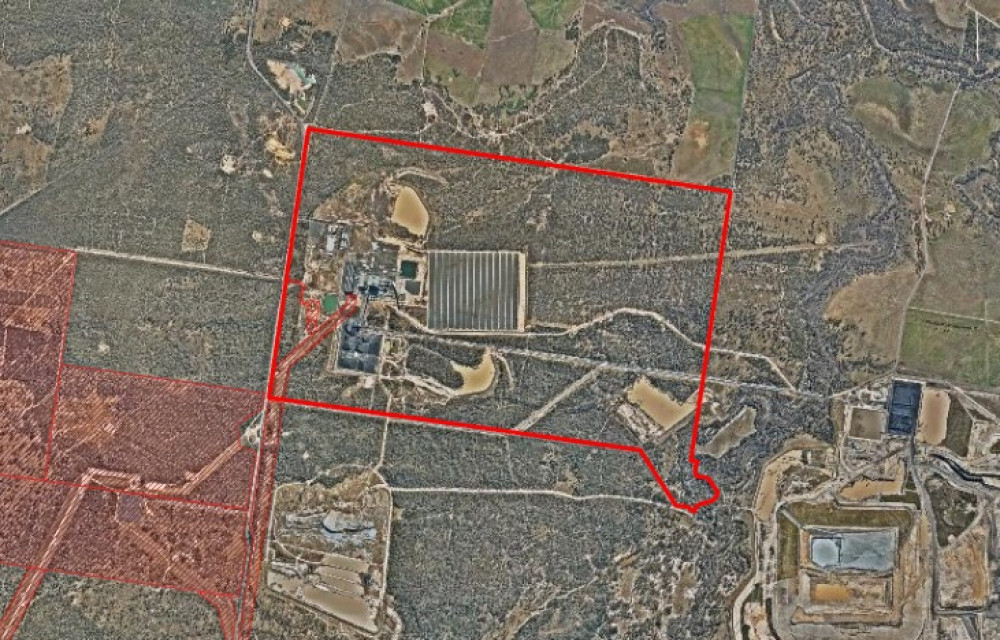 Aerial shot of a large-scale battery energy storage facility with modular units, electrical infrastructure and access roads set in a rural Queensland landscape